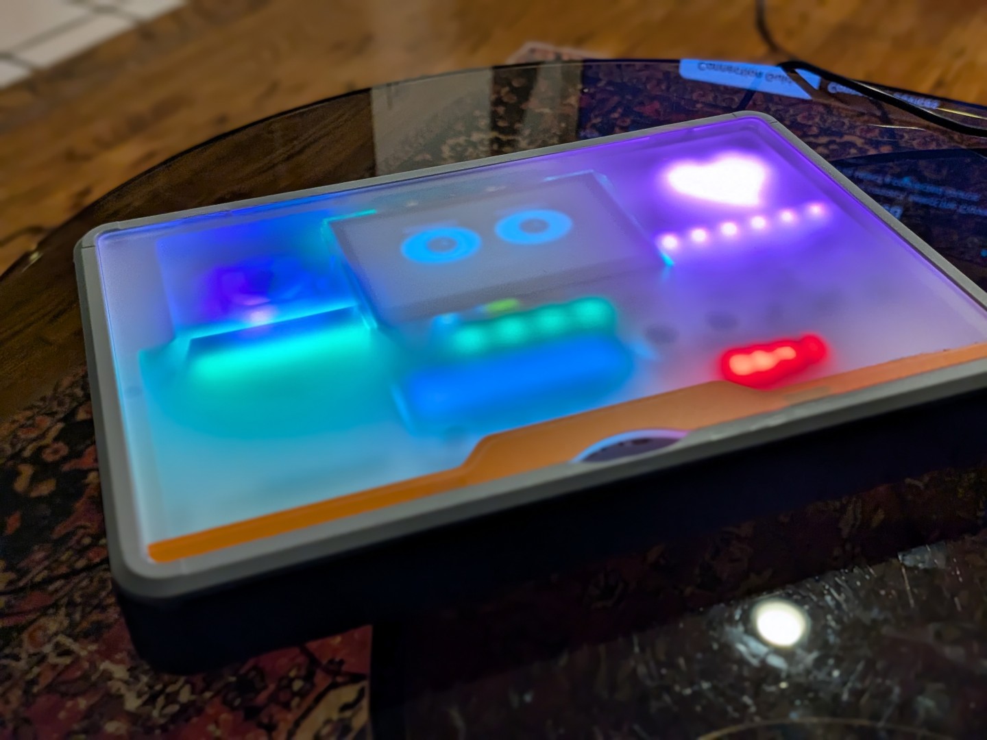 Sparkle's frosted cover at an angle, LEDs glowing teal, blue, and magenta through the frost