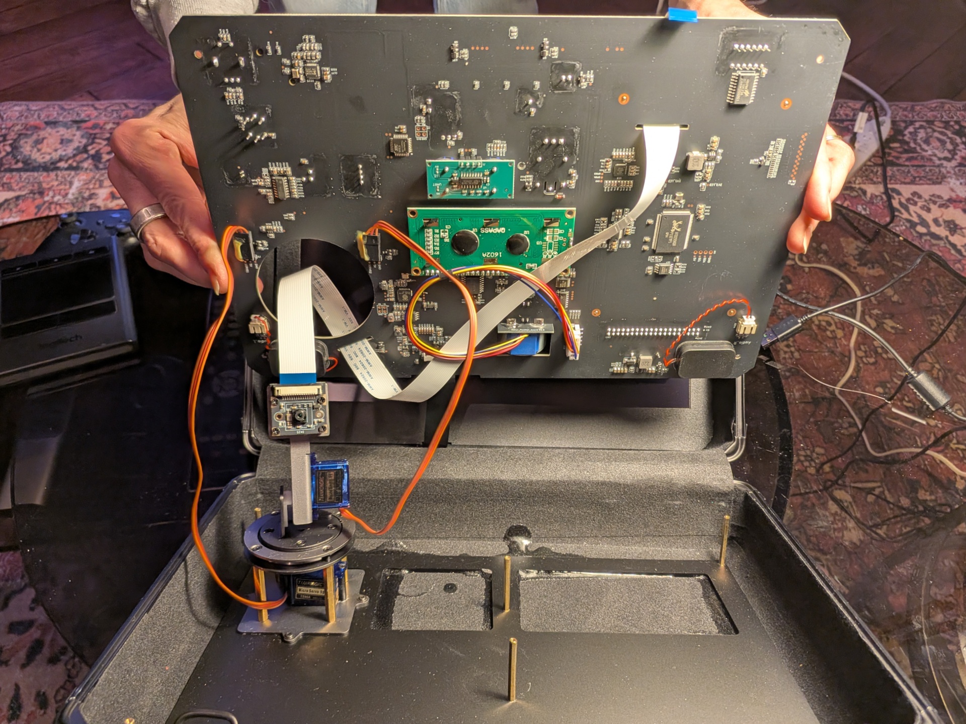 Sensor panel lifted out of the case revealing camera gimbal and wiring